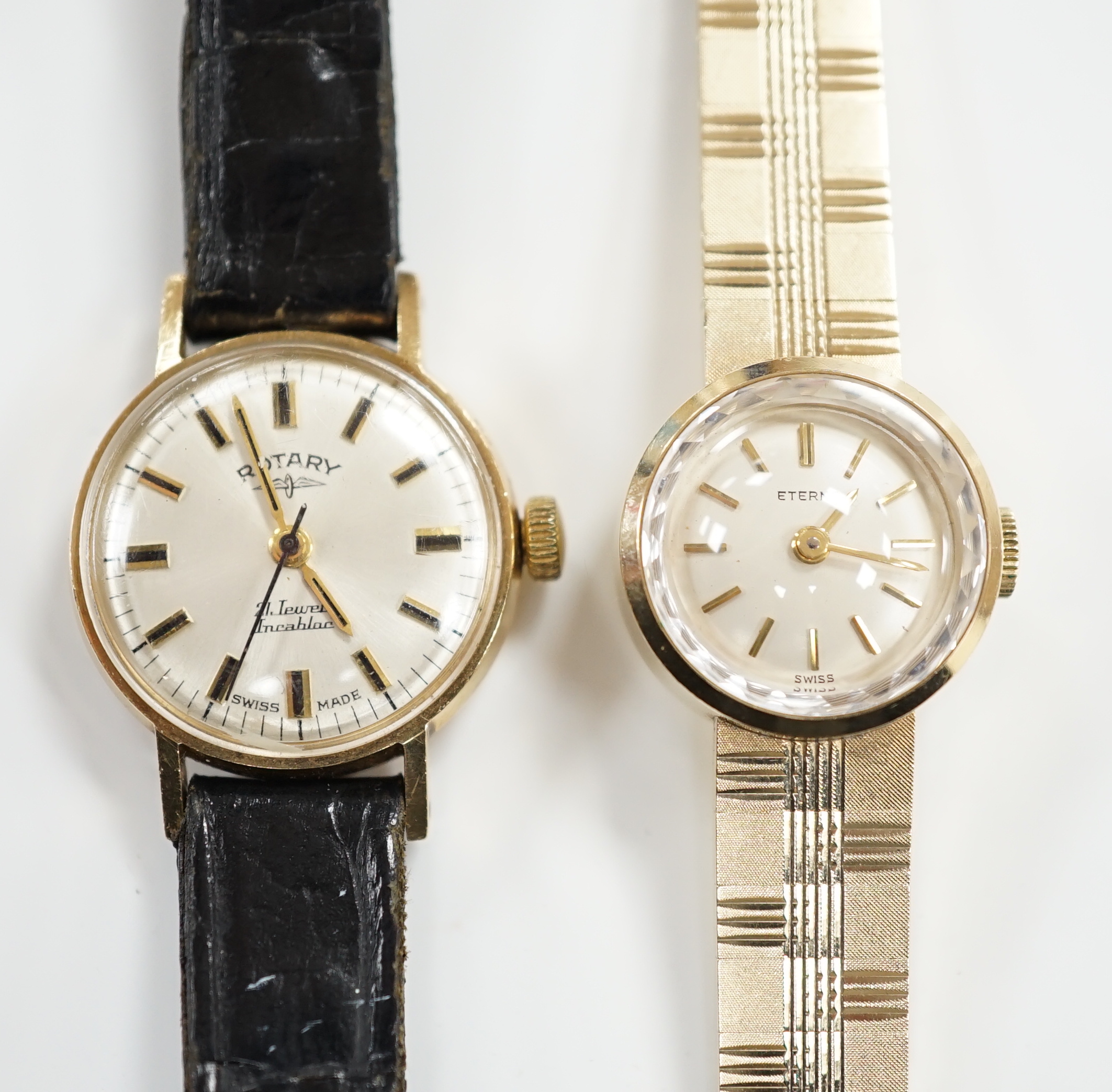 A lady's 9ct gold Eterna manual wind wrist watch, on a 9ct gold integral bracelet, overall 16.2cm, gross weight 23.7 grams, together with a lady's 9ct gold Rotary manual wind wrist watch, on a leather strap.